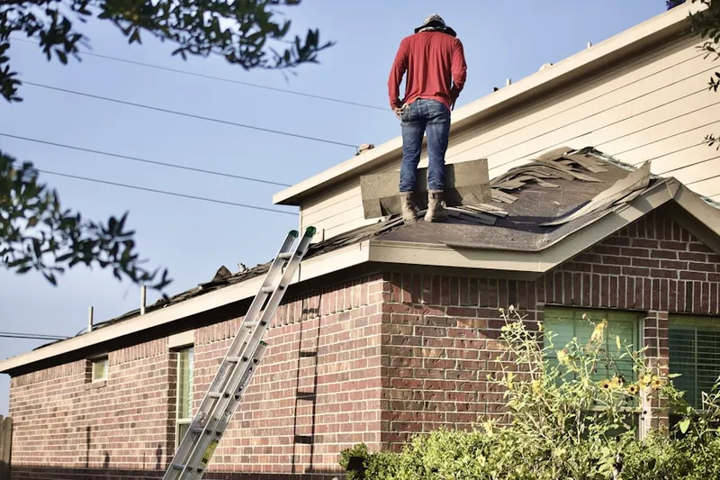 Professional roofer working on a residential roof in Meadowlawn